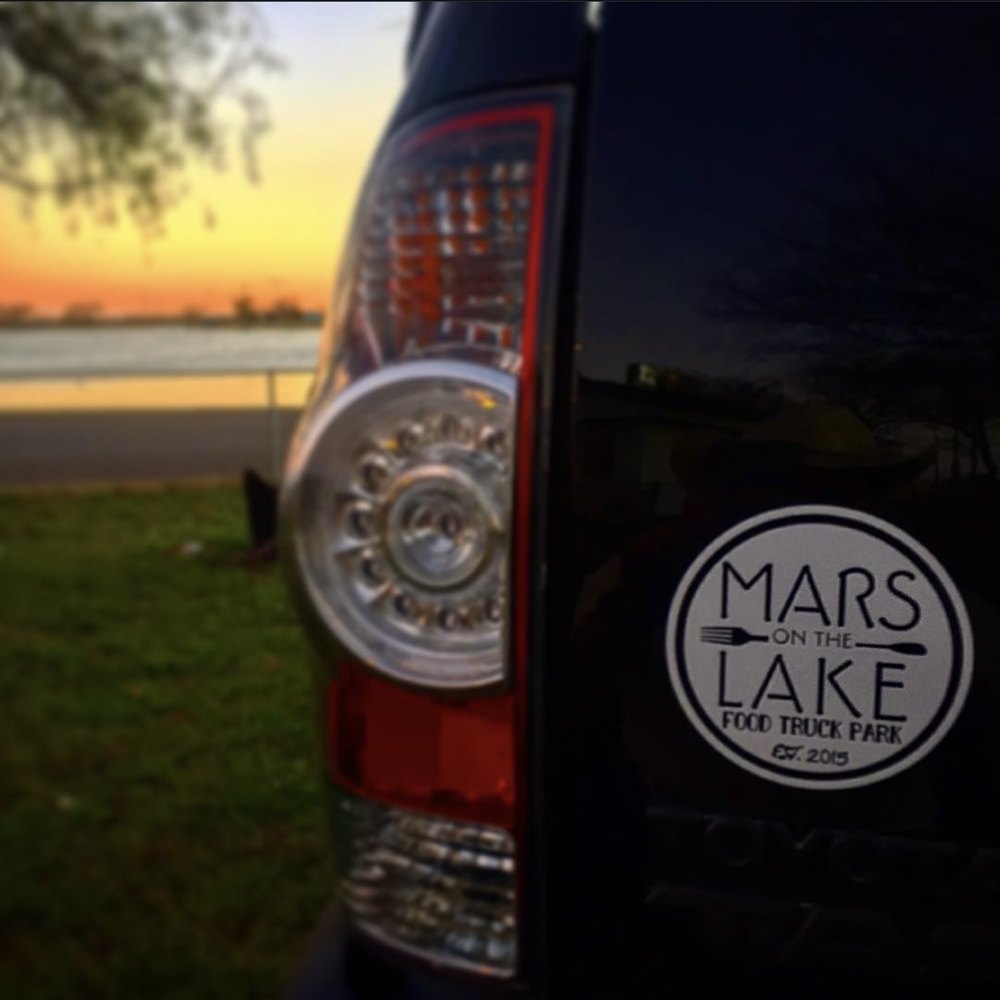 Mars on the Lake Food Truck Park decal at sunset by the water