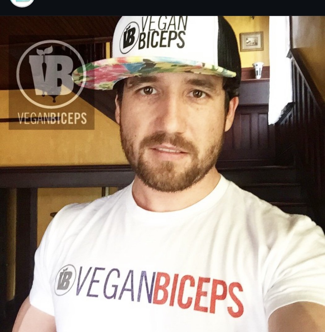 Frank Flores wearing his Vegan Biceps hat and shirt