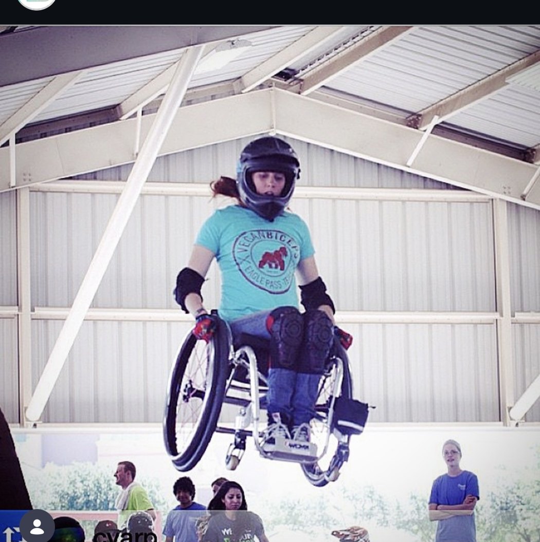 Adaptive athlete Katherine Beattie getting big air at WCMX in a Vegan Biceps shirt